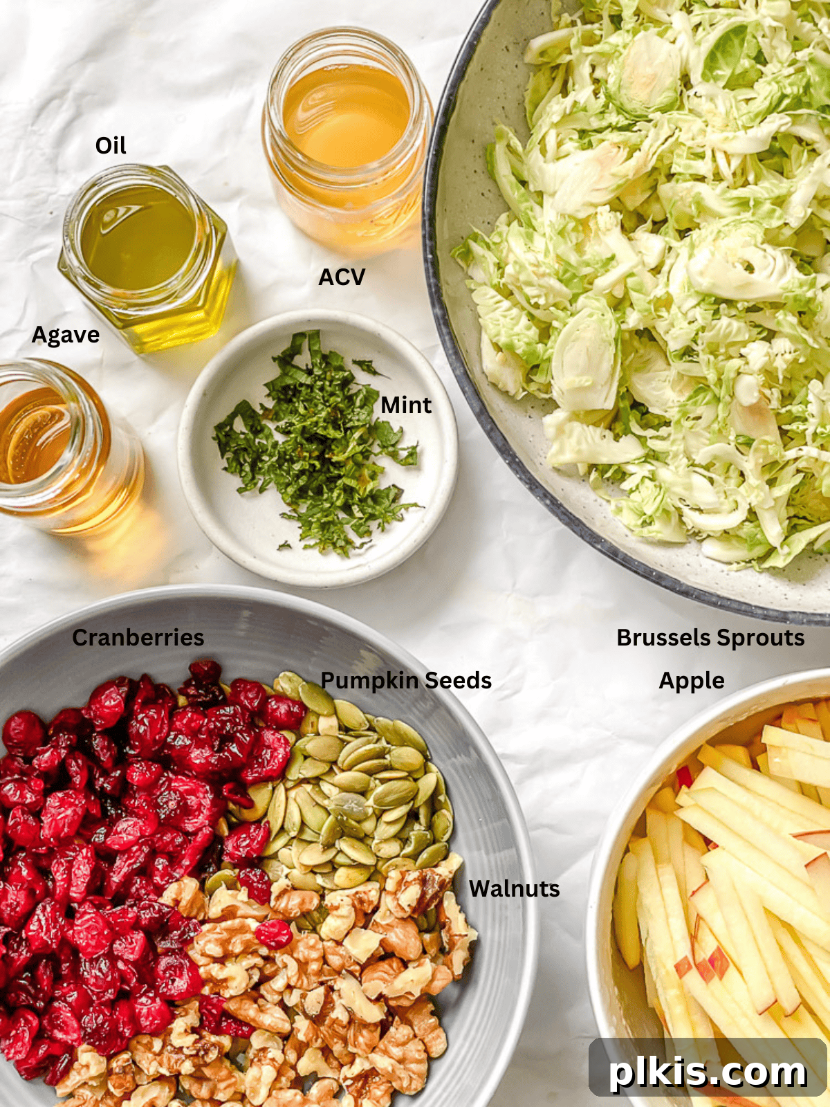 Ingredients for a shaved brussels sprouts salad in individual bowls.