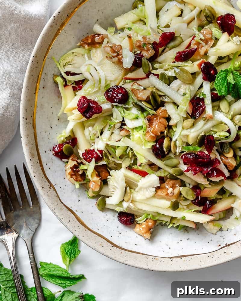 Completed Shaved Brussels Sprouts Salad in a bowl with a fork.
