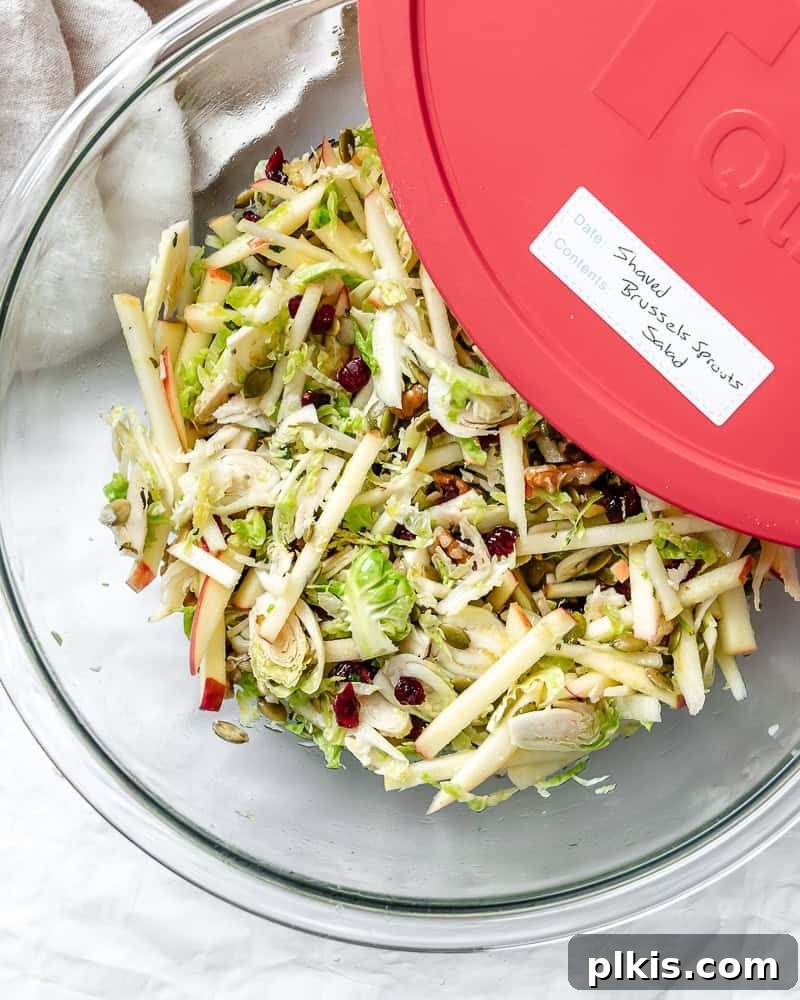 Completed Shaved Brussels Sprouts Salad in a storage container.