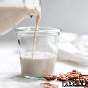 completed pecan milk being poured into cup