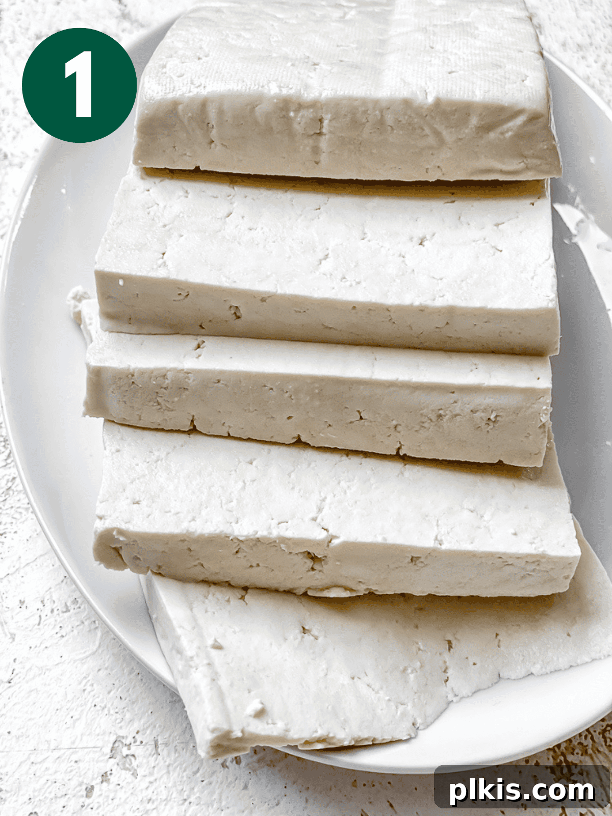 Chipotle Spiced Tofu 4 thick tofu slices on a white plate.