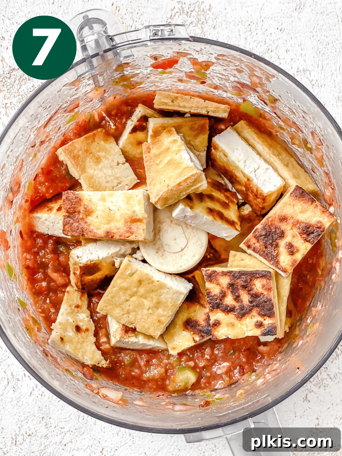 Chipotle Spiced Tofu 10 fried tofu pieces on top of a red salsa in a food processor.