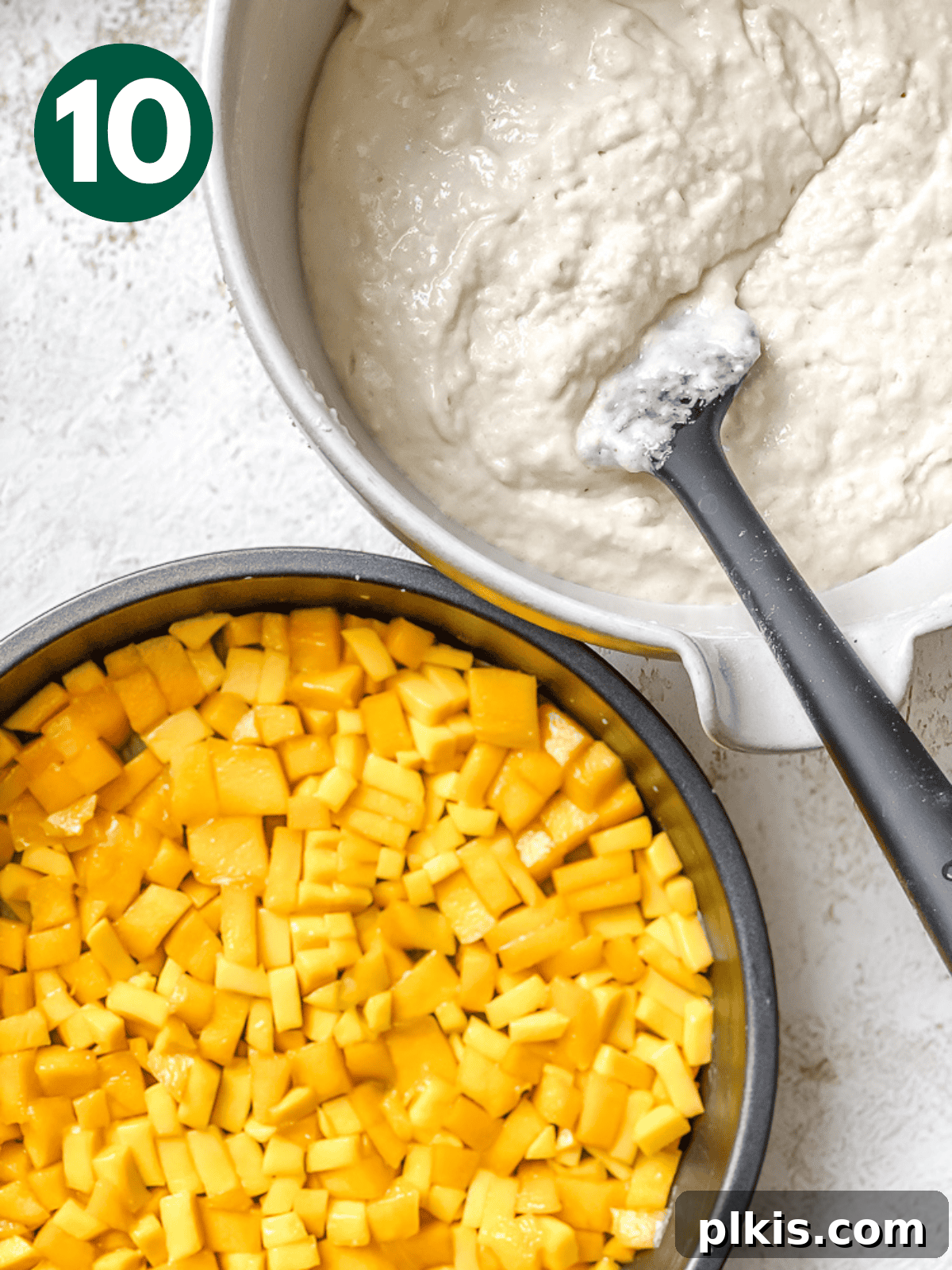 Tropical Mango Delight 13 mango cake batter in a bowl next to mango pieces in a cake pan.