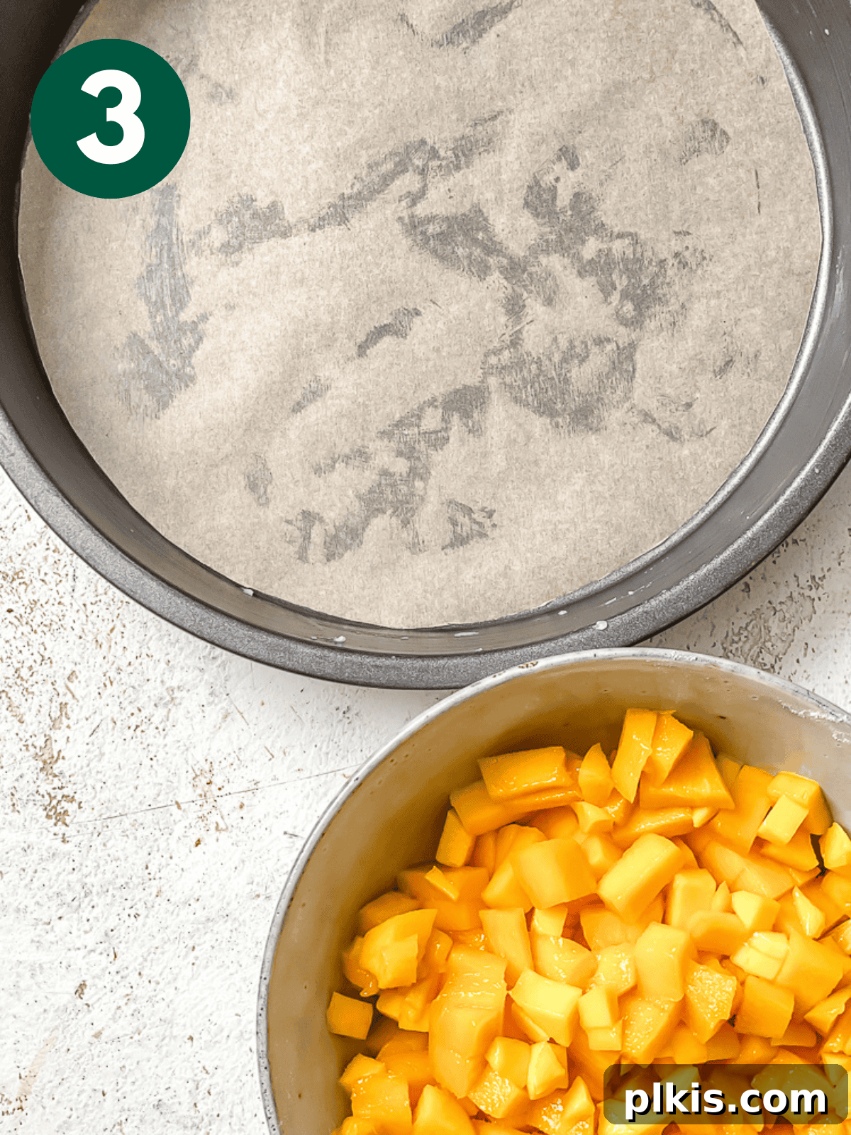 Tropical Mango Delight 6 a bowl of chopped mangoes next to a cake pan.