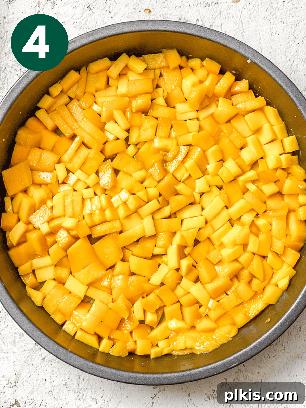 Tropical Mango Delight 7 chopped mango pieces arranged in a cake pan.