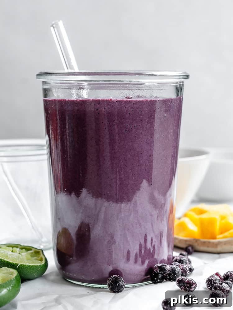Vibrant Mango Berry Bliss 6 Completed Mango Blueberry Smoothie in a glass, garnished and ready to drink.
