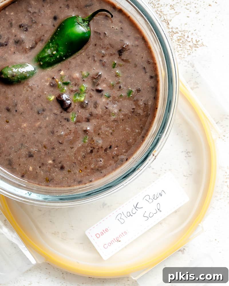 Spiced Black Bean Warmth 13 a batch of black bean soup in a glass storage container.