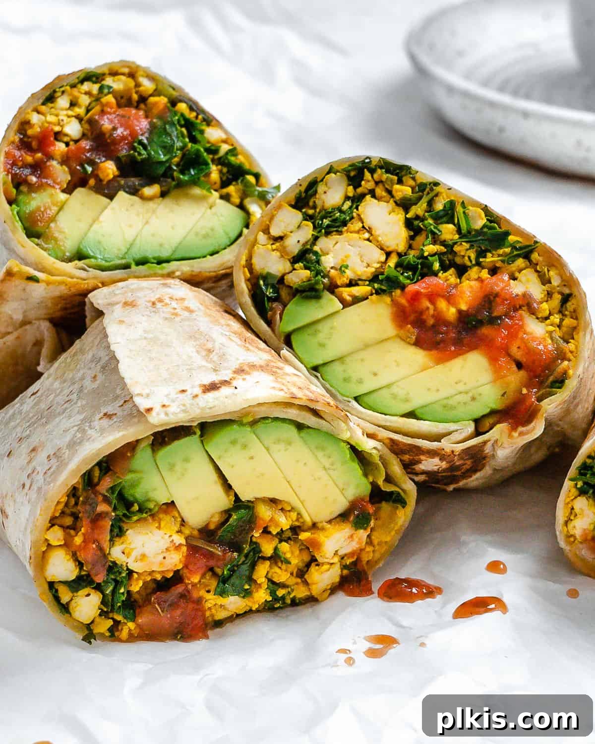 Effortless Plant-Based Breakfast Wrap 2 completed Easy Scrambled Tofu Breakfast Burritos on a white surface
