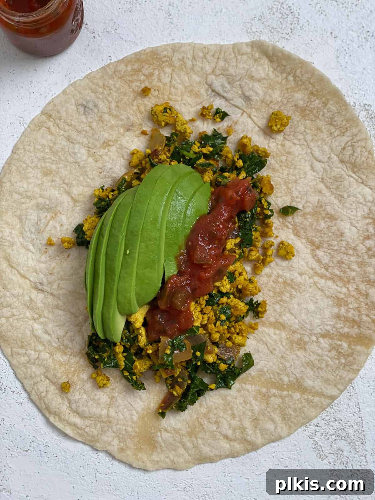 Effortless Plant-Based Breakfast Wrap 11 process shot of adding ingredients to tortilla