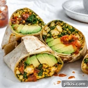 Effortless Plant-Based Breakfast Wrap 13 completed Easy Scrambled Tofu Breakfast Burritos on a white surface