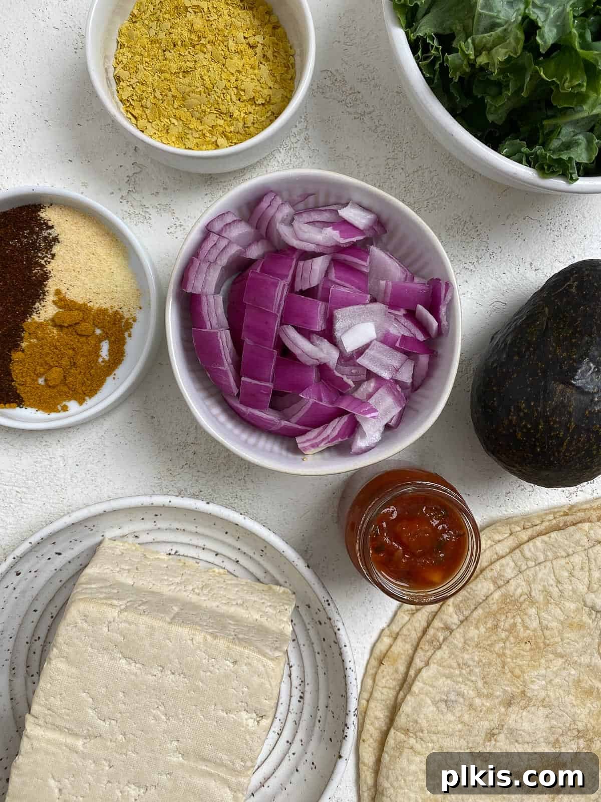 Effortless Plant-Based Breakfast Wrap 3 ingredients for Easy Scrambled Tofu Breakfast Burrito measured out against a light surface
