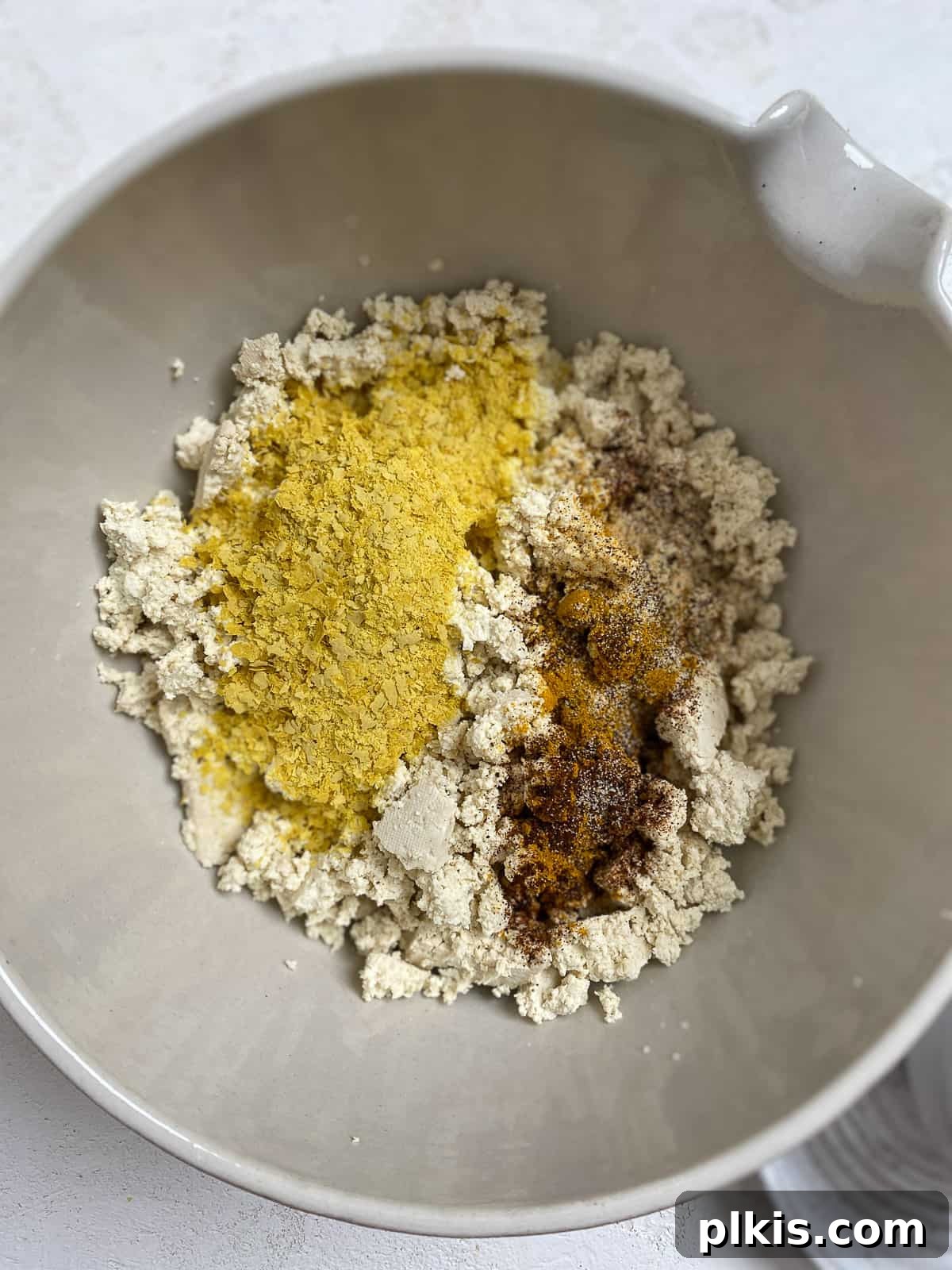 Effortless Plant-Based Breakfast Wrap 5 process shot of adding tofu mixture together in bowl