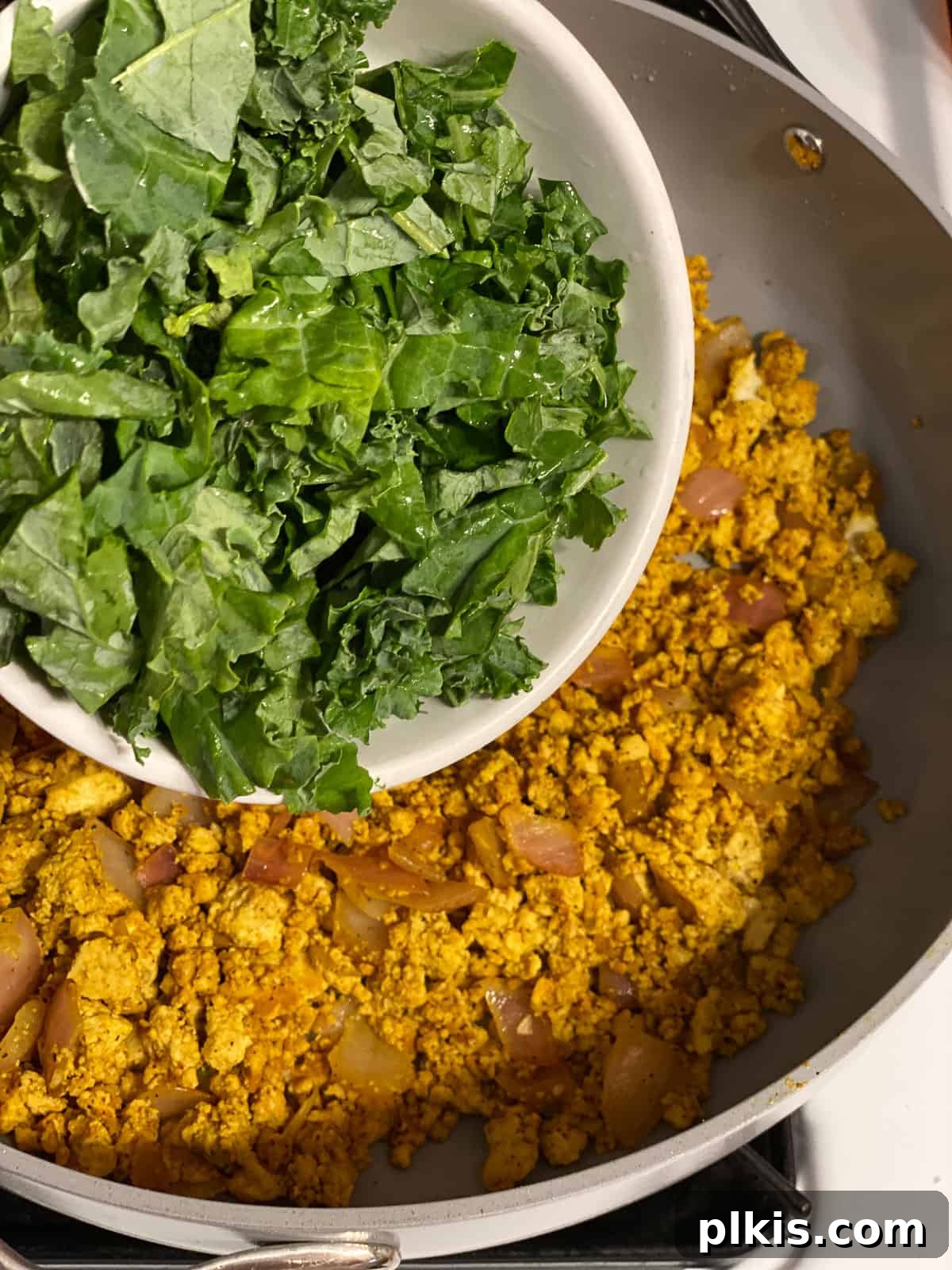 Effortless Plant-Based Breakfast Wrap 10 process shot of adding kale to pan