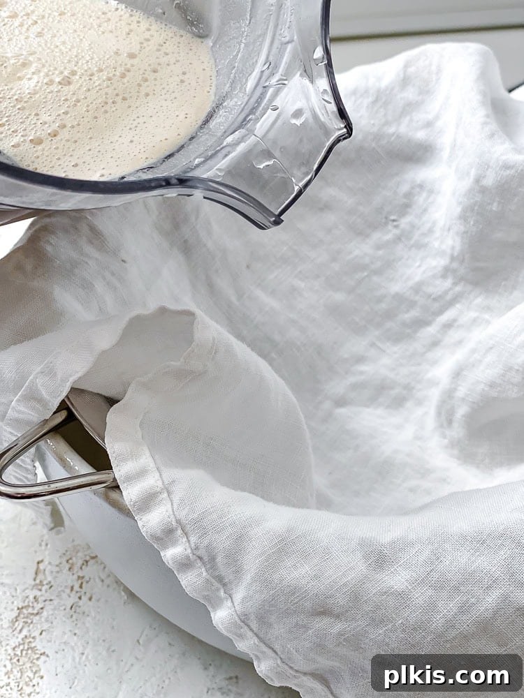 Crafting Your Own Creamy Peanut Milk 5 process shot of using a cheesecloth for peanut milk