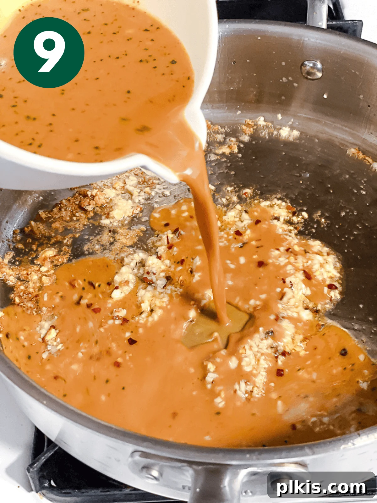 Crispy Tangy Tofu Delight 12 Pouring the pre-mixed General Tso's sauce into a large metal pan with aromatics.