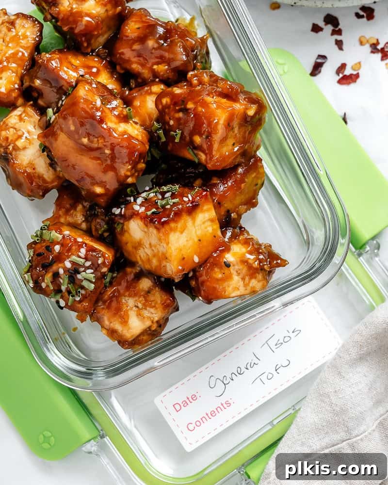 Crispy Tangy Tofu Delight 17 General Tso's tofu stored in a clear glass container, ready for meal prep.