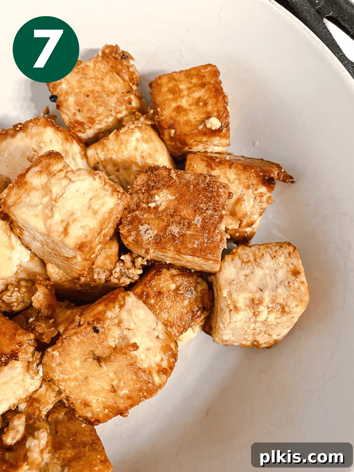 Crispy Tangy Tofu Delight 10 Close-up of perfectly fried, golden-brown tofu cubes in a white bowl.