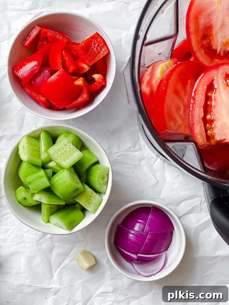 Vibrant Summer Gazpacho 4 ingredients for Tomato Gazpacho measured out on a white surface