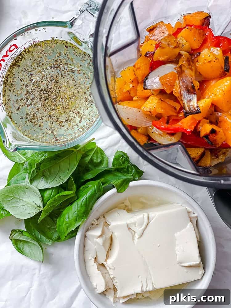 Velvety Roasted Butternut and Red Pepper Soup 7 Ingredients for Butternut Squash Red Pepper Soup, including silken tofu, broth, and fresh basil, measured on a white surface.