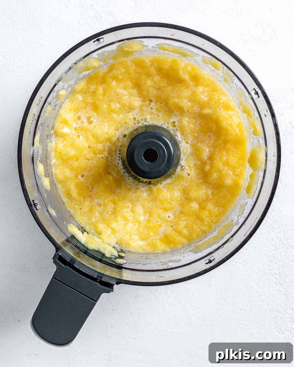Tropical Vegan Coconut Pineapple Pie 5 Process shot showing the pineapple after being blended in the food processor, now a crushed consistency.
