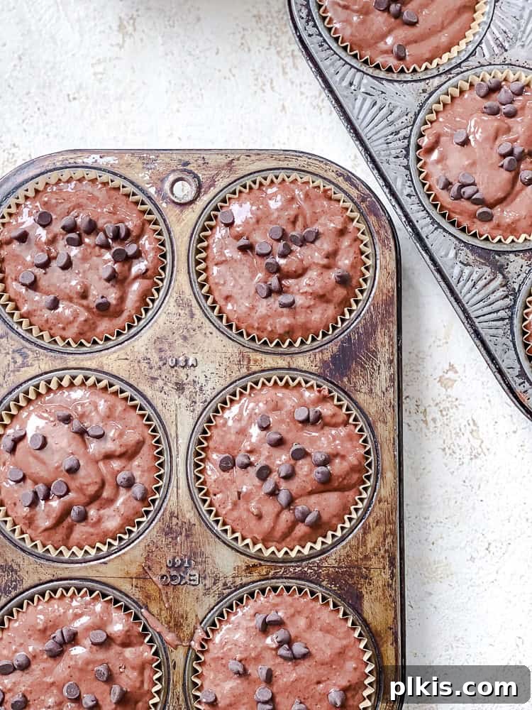 Decadent Double Chocolate Muffins 9 Process shot of unbaked muffins in a muffin tin, ready to go into the oven.