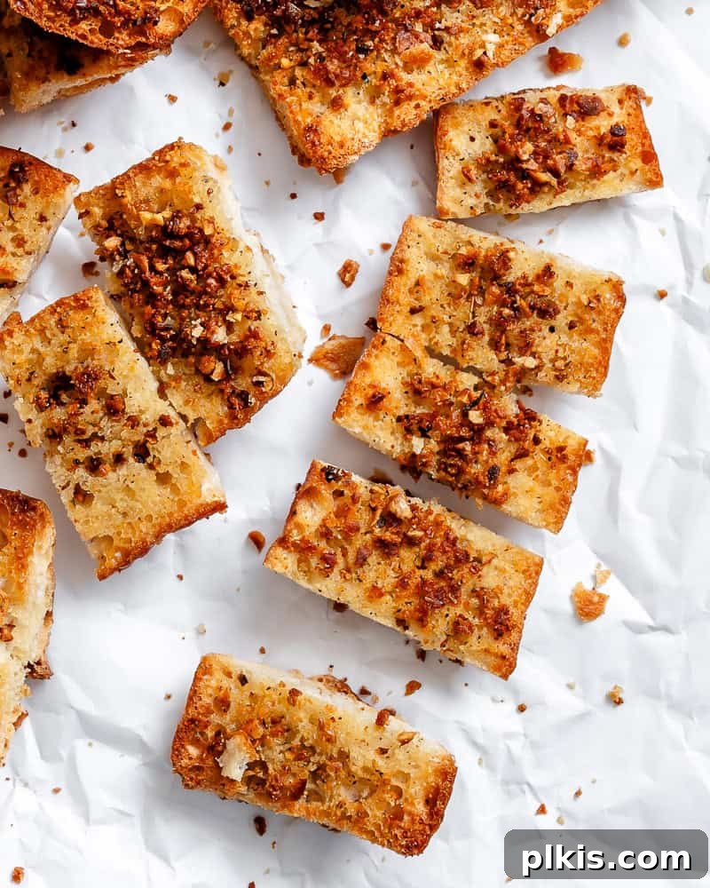 Effortless Plant-Based Garlic Bread 10 A close-up of several Easy Vegan Garlic Bread slices, showcasing their golden crust and fluffy interior, ready to be enjoyed.
