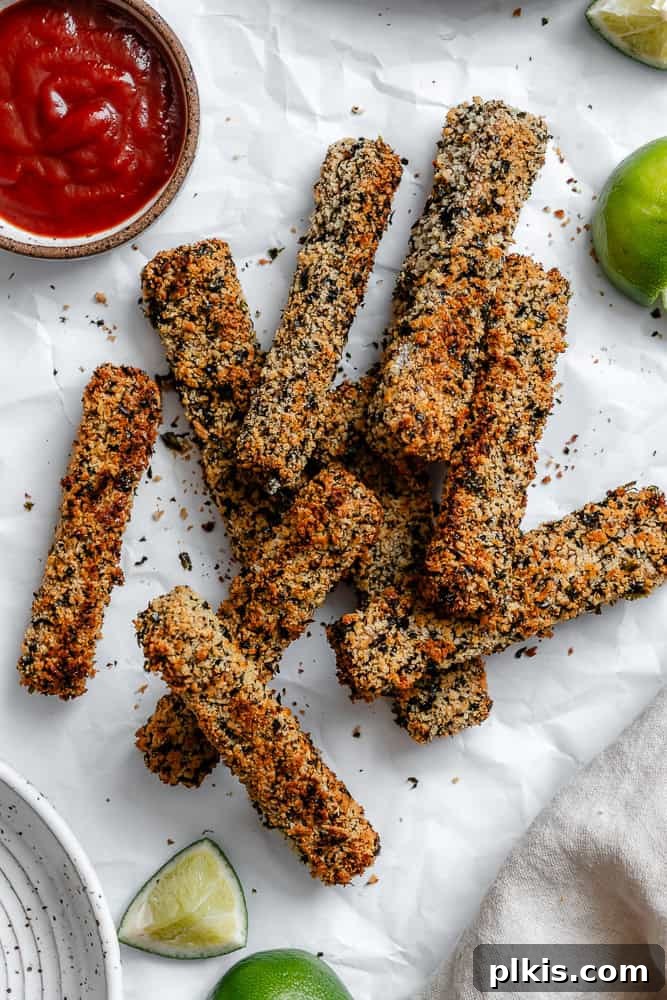 Crispy Vegan Fish Fingers 2 Crispy golden vegan fish sticks served on a white platter, ready to be enjoyed.