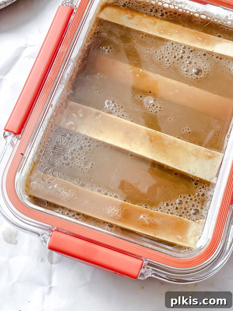 Crispy Vegan Fish Fingers 5 Process shot showing tofu marinating in a lidded container, soaking up flavors.