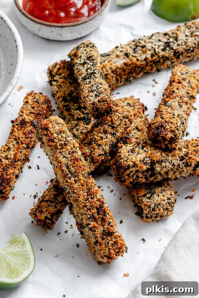 Crispy Vegan Fish Fingers 9 A close-up shot of perfectly golden and crispy vegan fish sticks, showcasing their enticing texture.