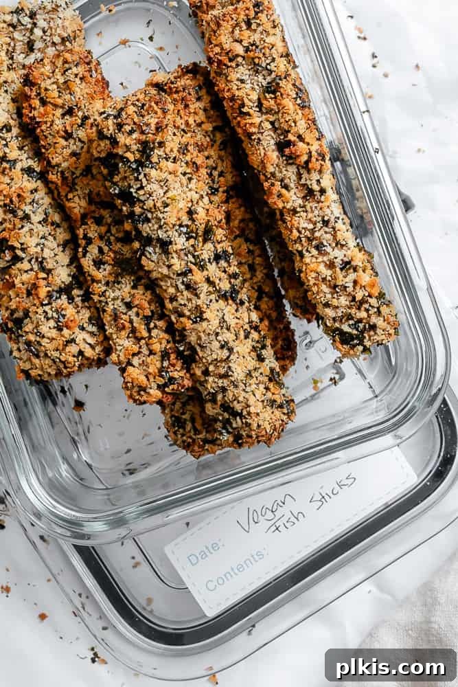 Crispy Vegan Fish Fingers 10 Cooked vegan fish sticks neatly packed into an airtight storage container, ready for refrigeration.