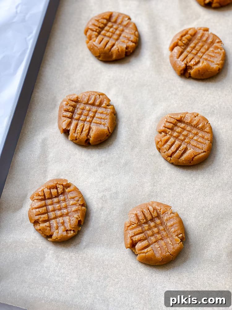 Plant-Based Peanut Butter Perfection 9 pre-baked cookies on baking sheet