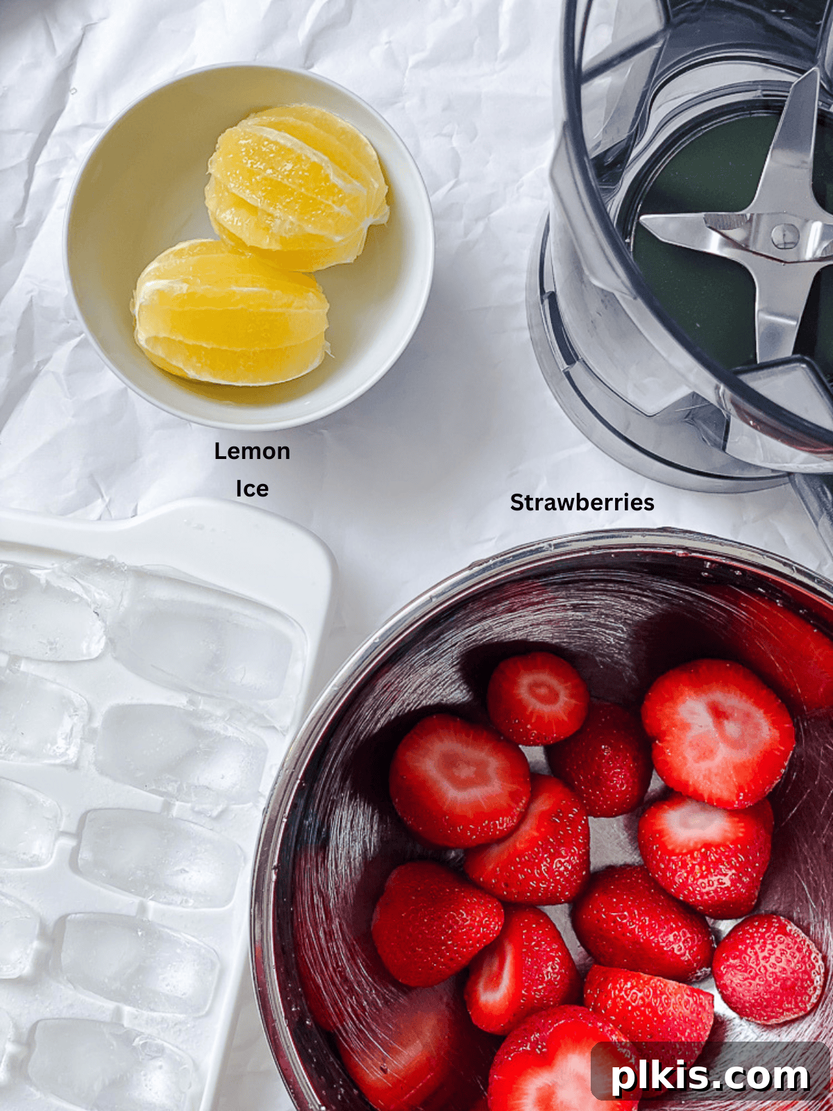 Effortless Strawberry Lemonade in Minutes 3 Ingredients for a 5-minute Fresh Strawberry Lemonade recipe, including fresh strawberries, lemons, water, and sweetener, neatly arranged on a white surface.