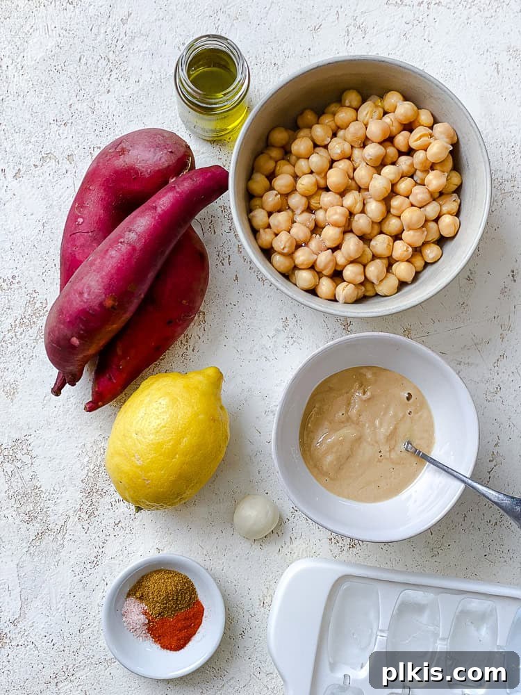 Golden Sweet Potato Hummus 3 Individual white bowls containing the ingredients for sweet potato hummus, including chickpeas, tahini, lemon, garlic, and spices.