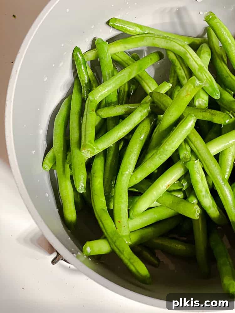 Zesty Green Bean Salad 4 process shot showing green beans in a pot of boiling water
