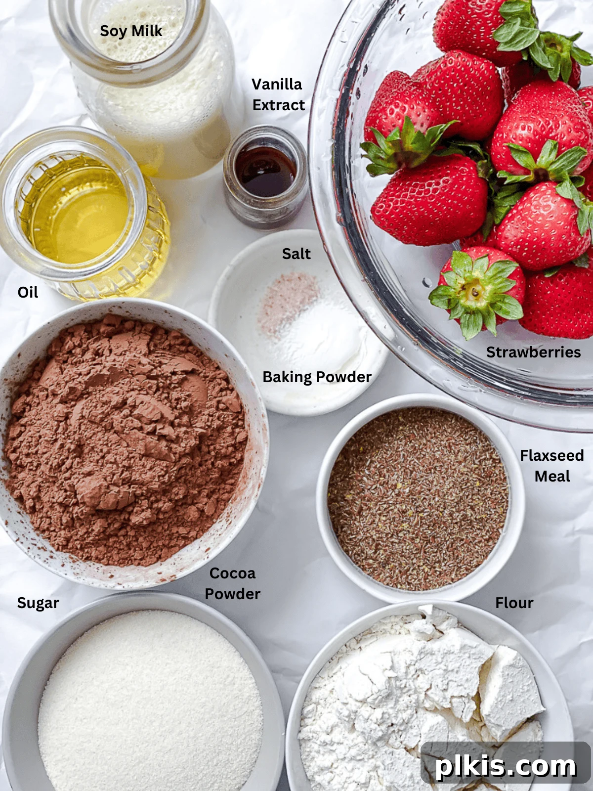 Strawberry Kissed Brownies 3 All the ingredients for Strawberry Brownies, neatly measured out in bowls and containers on a pristine white surface.