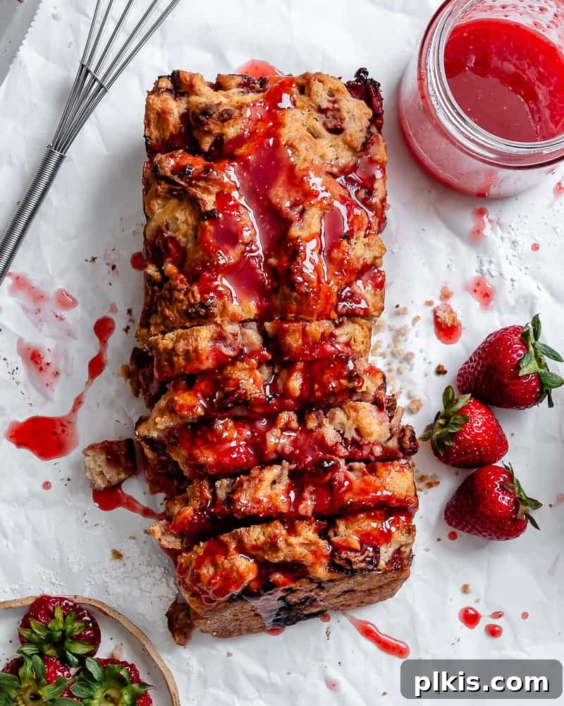 Effortless Strawberry Glaze for All Your Sweet Treats 6 A baked good, possibly a donut or muffin, being drizzled with the freshly made easy strawberry glaze, showing its beautiful pink color and smooth flow.