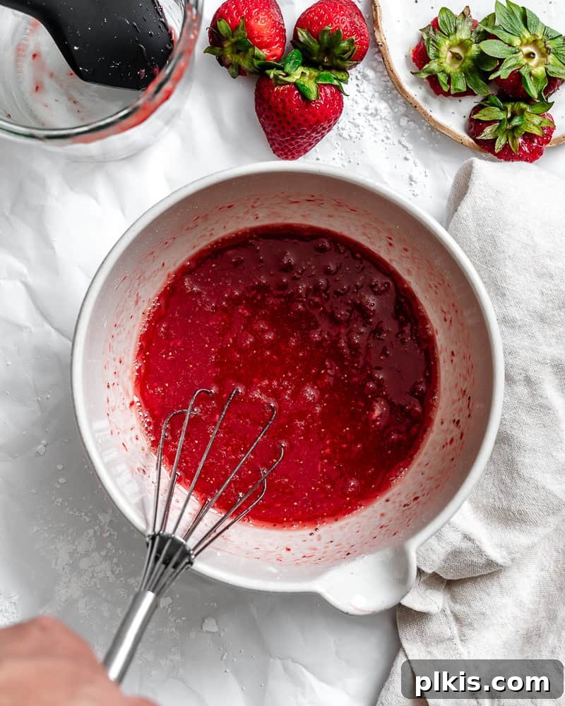 Effortless Strawberry Glaze for All Your Sweet Treats 7 The completed Easy Strawberry Glaze in a bowl, showing its smooth texture and vibrant pink color, ready to be used.