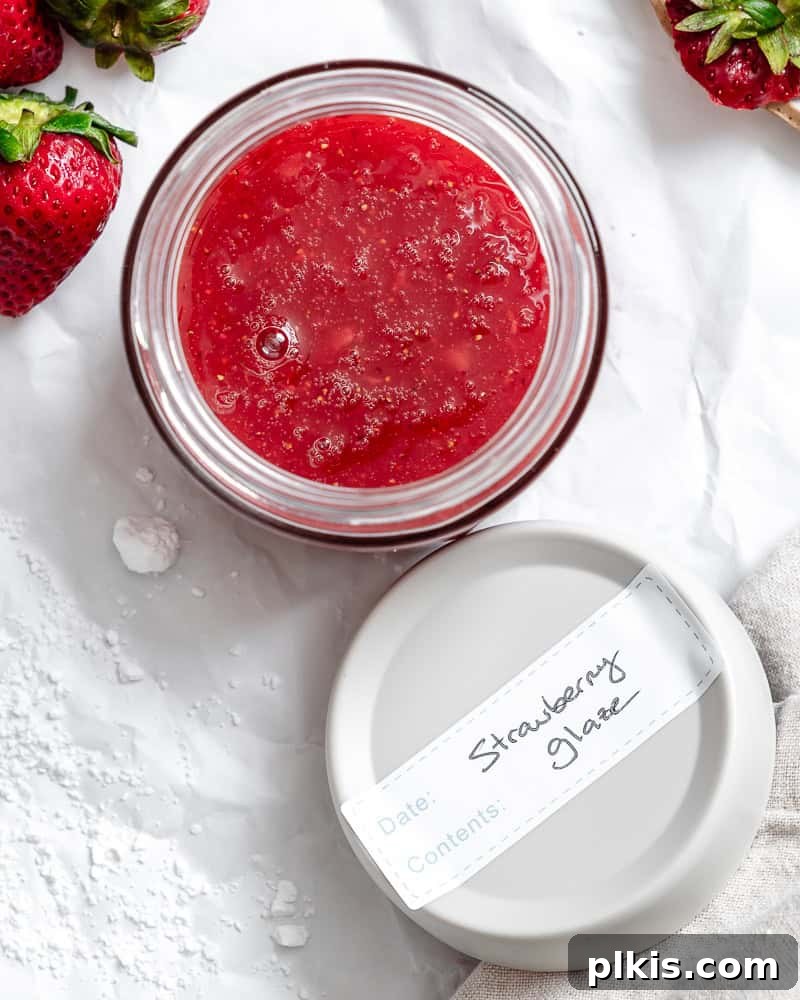 Effortless Strawberry Glaze for All Your Sweet Treats 8 The completed Easy Strawberry Glaze stored in a clear airtight container, ready for refrigeration.