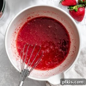 Effortless Strawberry Glaze for All Your Sweet Treats 9 Completed Easy Vegan Strawberry Glaze in a bowl, showing its smooth texture and vibrant pink color.