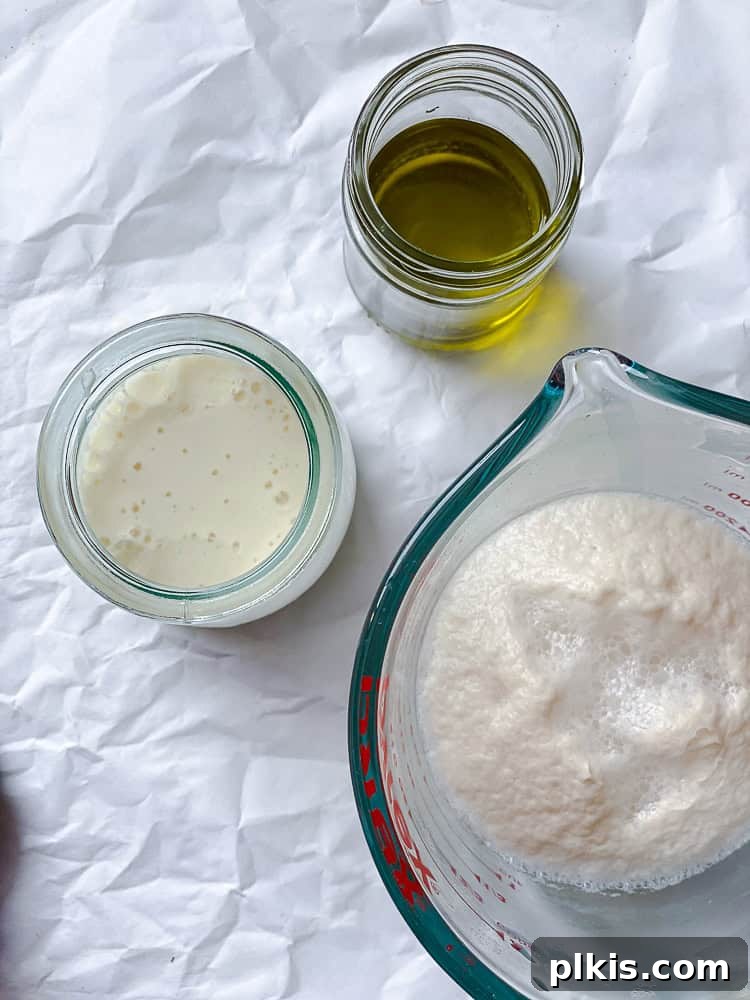 Fluffy Vegan Naan 7 Various wet ingredients for vegan naan, including the milk mixture and oil, in separate glass jars.