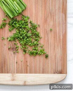 Crispy Quinoa Bites 5 cut up chives on a brown cutting board