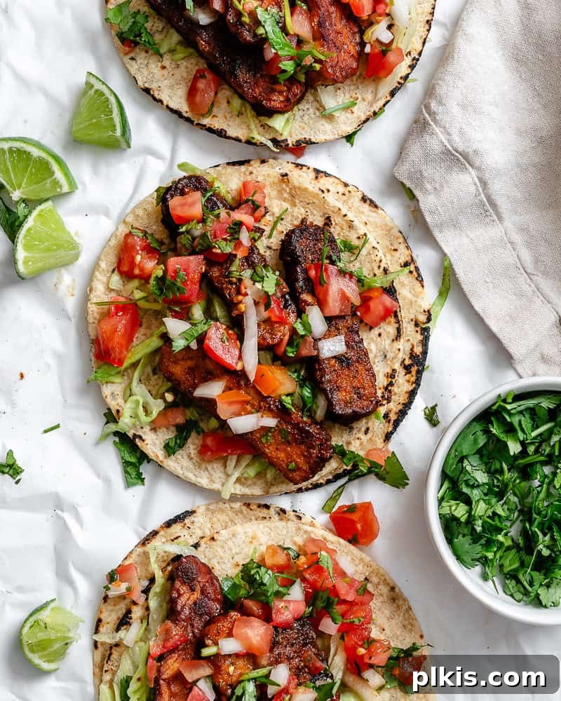 Speedy Tempeh Tacos 7 Completed Easy Tempeh Tacos with all toppings, served on a white surface