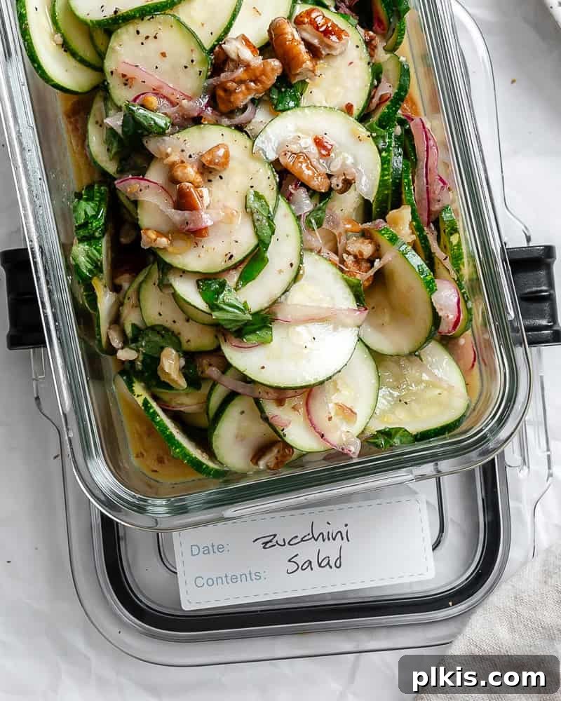Zesty Zucchini Salad 11 Leftover zucchini salad neatly packed in a clear storage container, ready for the fridge.