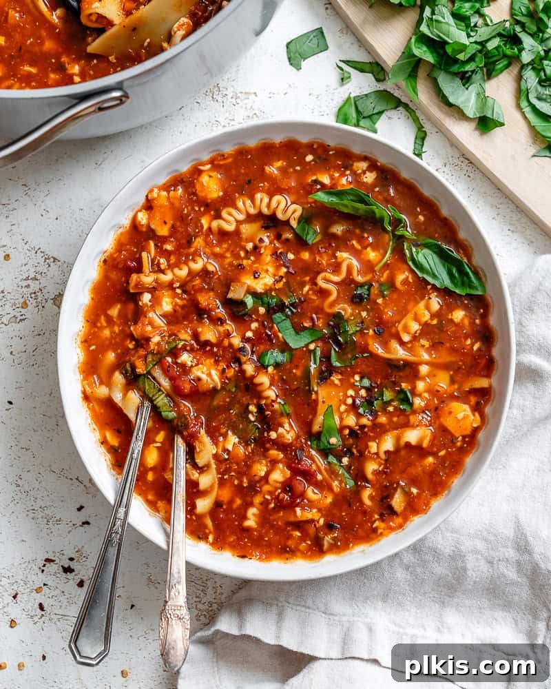 Tuscan Vegan Lasagna Soup 2 A vibrant bowl of vegan lasagna soup, garnished with fresh basil, ready to be enjoyed.