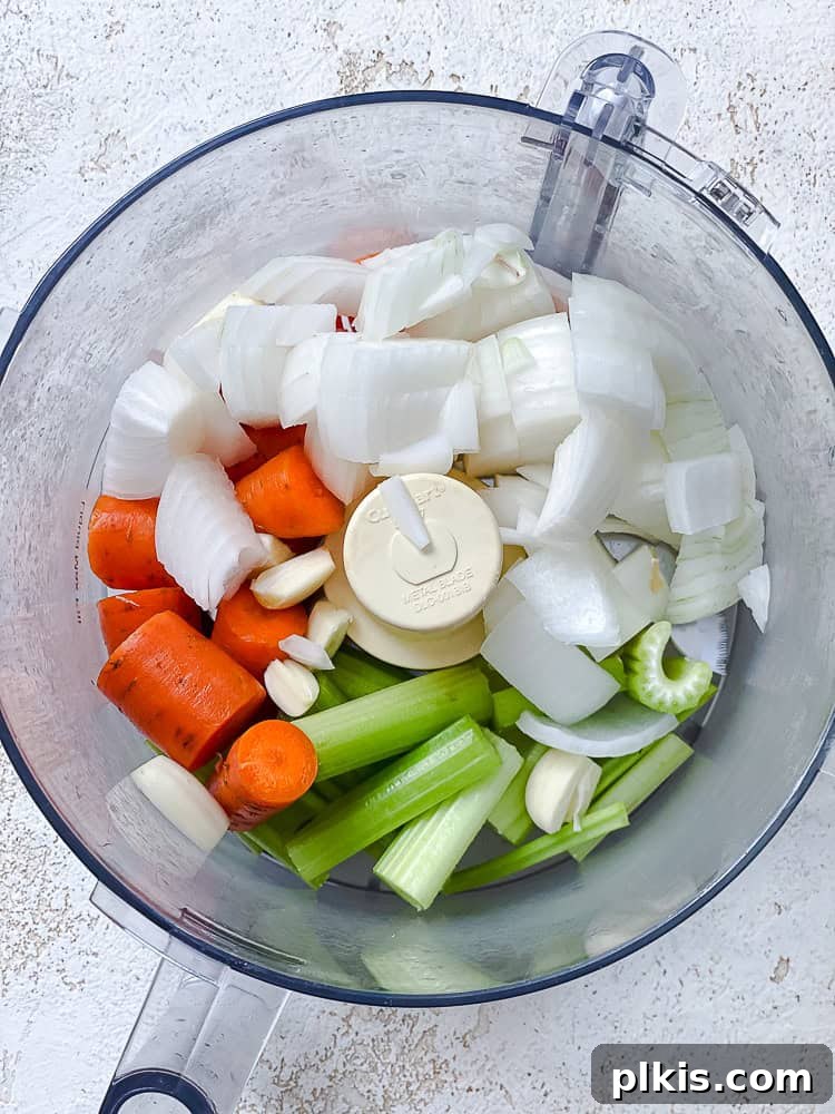 Tuscan Vegan Lasagna Soup 4 Roughly chopped onions, carrots, and celery waiting in a food processor for pulsing.