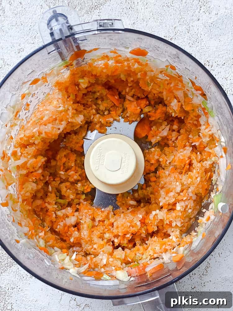 Tuscan Vegan Lasagna Soup 5 Finely chopped vegetables (onions, carrots, celery, garlic) in a food processor bowl.