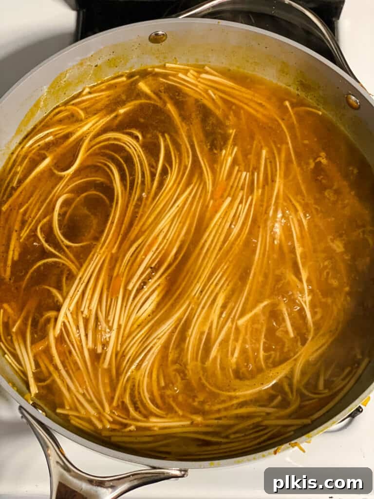 Filipino Pancit Bihon Noodles 15 process shot of noodles cooking in broth