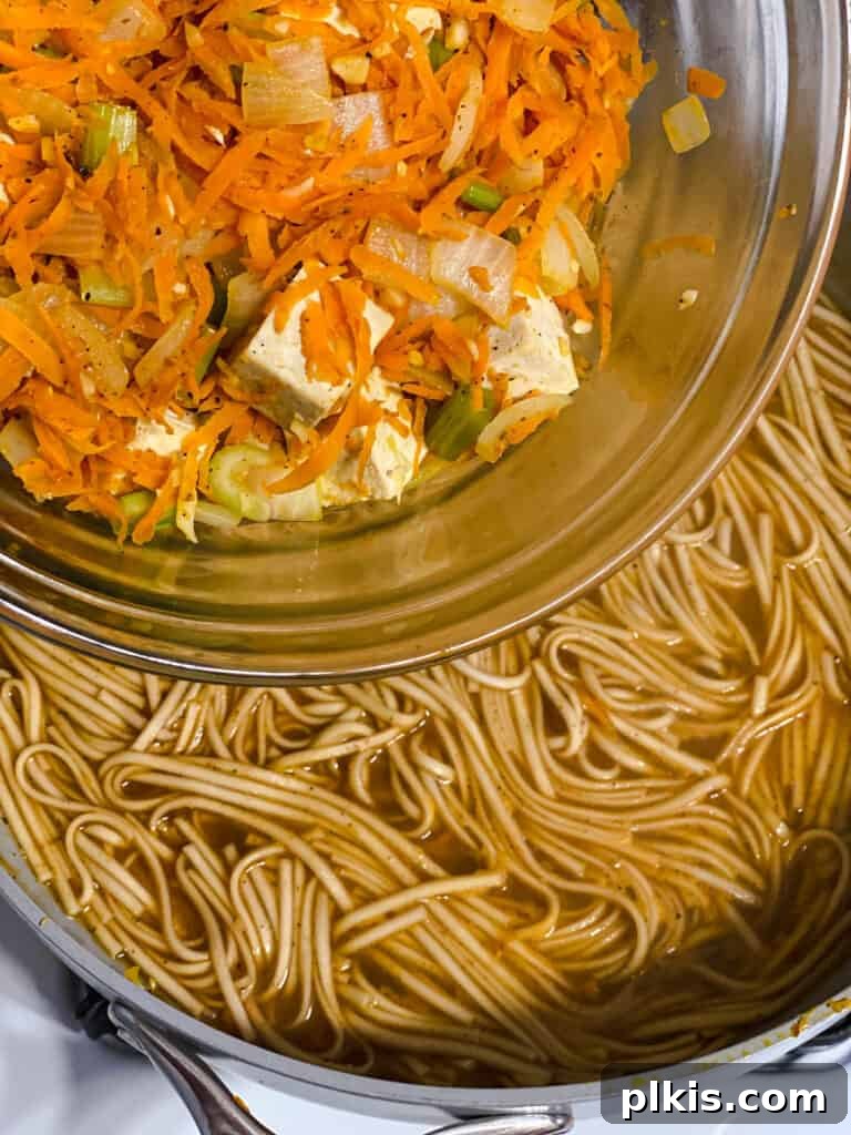 Filipino Pancit Bihon Noodles 16 process shot of adding veggie and tofu mix to noodles