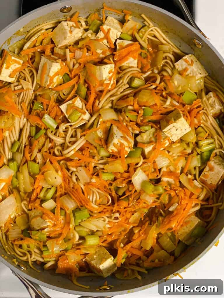 Filipino Pancit Bihon Noodles 17 process shot of ingredients being mixed and cooked in a pan