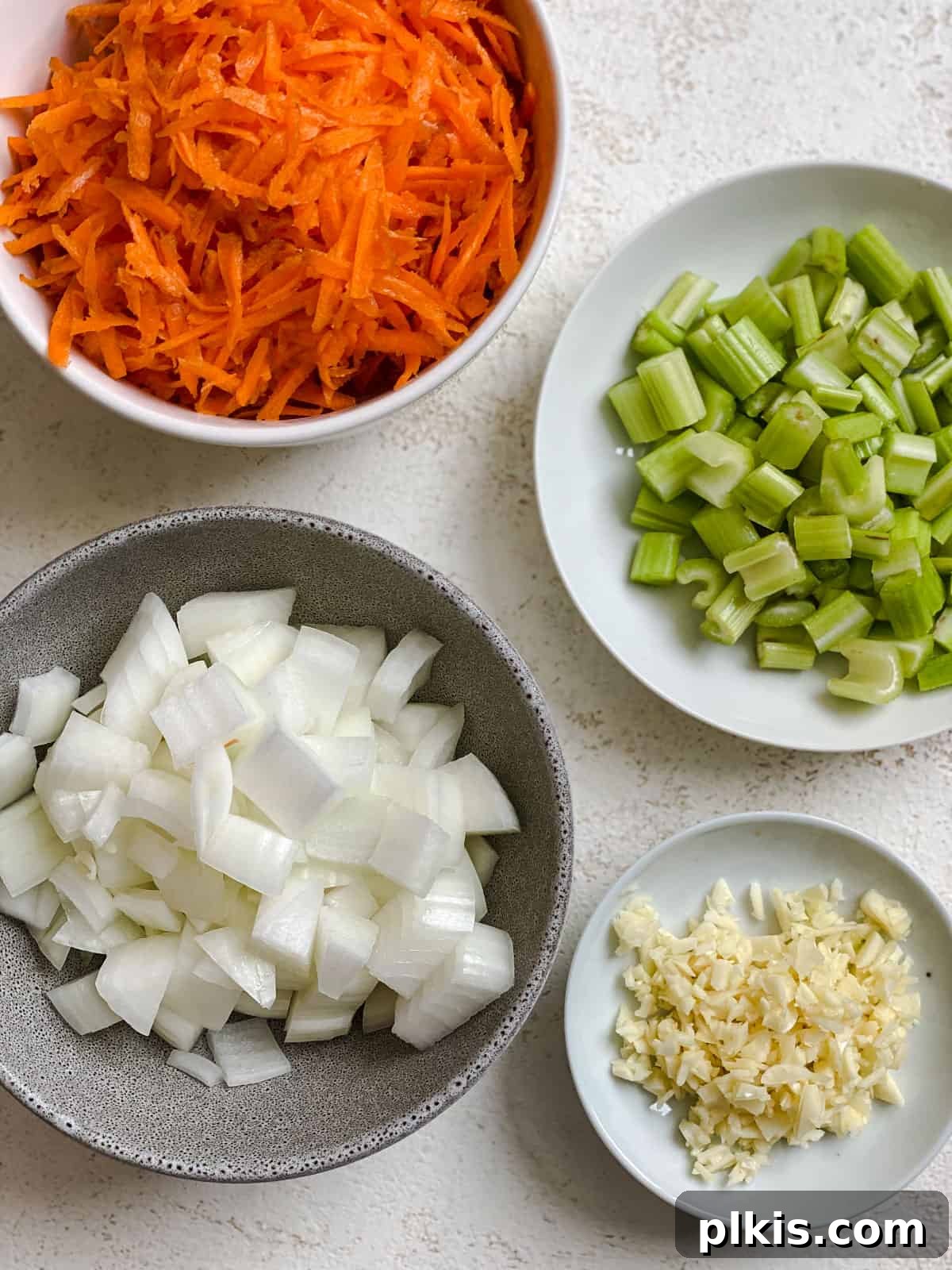 Filipino Pancit Bihon Noodles 4 ingredients for Pancit Bihon measured out against a white surface